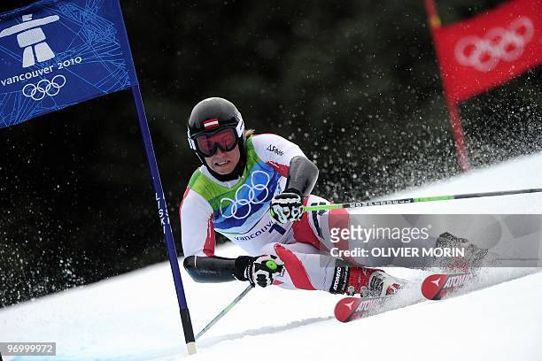 Austria's Marcel Hirscher clears a gate during the Men's Vancouver 2010 Winter Olympics Giant slalom event at Whistler Creek side Alpine skiing venue...
