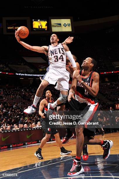 Devin Harris of the New Jersey Nets shoots against Marcus Camby of the Portland Trail Blazers during the game on February 23, 2010 at the Izod Center...
