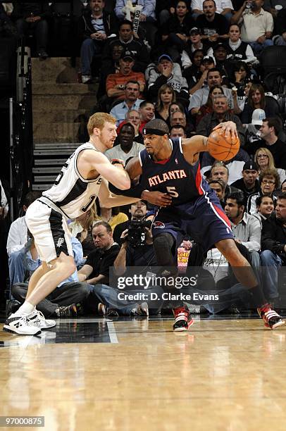 Josh Smith of the Atlanta Hawks posts up against Matt Bonner of the San Antonio Spurs during the game at AT&T Center on January 27, 2010 in San...