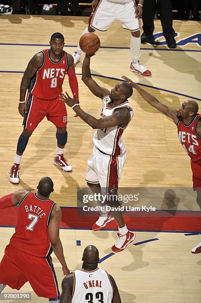 Jawad Williams of the Cleveland Cavaliers goes up for a shot against Tony Battie, Terrence Williams and Trenton Hassell of the New Jersey Nets during...