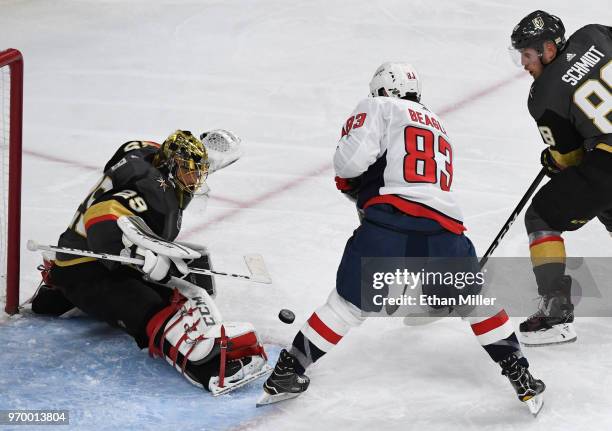 Marc-Andre Fleury of the Vegas Golden Knights blocks a shot by Jay Beagle of the Washington Capitals as Nate Schmidt of the Golden Knights defends in...