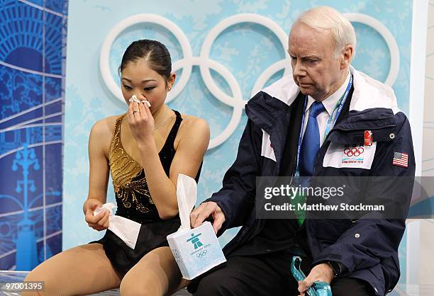 Mirai Nagasu of the United States wipes blood from her nose in the kiss and cry area in the Ladies Short Program Figure Skating on day 12 of the 2010...