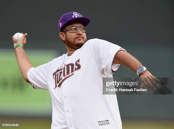 Omarr Baker, brother of the late Prince, delivers a ceremonial pitch before the game between the Minnesota Twins and the Los Angeles Angels of...