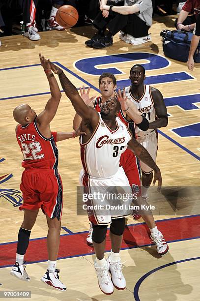 Jarvis Hayes of the New Jersey Nets shoots over Shaquille O'Neal of the Cleveland Cavaliers during the game at Quicken Loans Arena on February 9,...