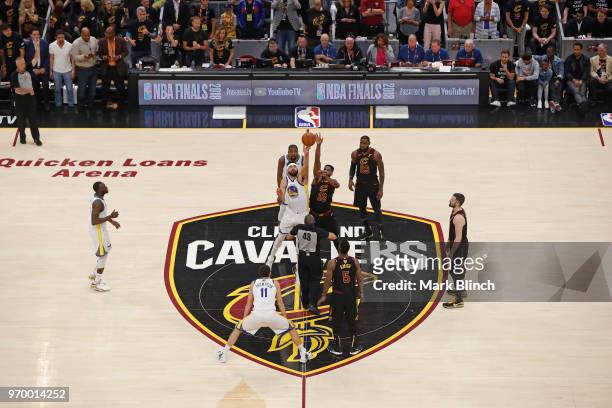 JaVale McGee of the Golden State Warriors and Tristan Thompson of the Cleveland Cavaliers go up for the opening tip off in Game Four of the 2018 NBA...