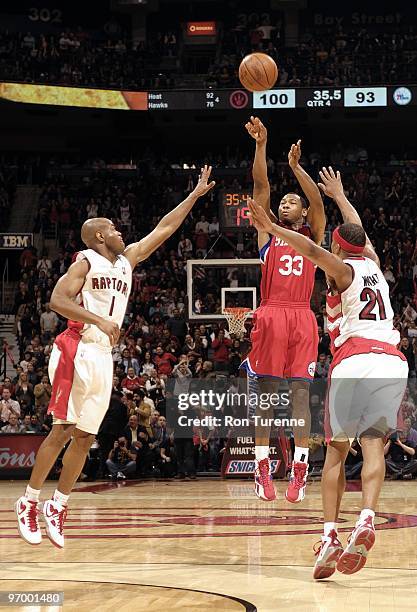 Willie Green of the Philadelphia 76ers shoots a jump shot against Jarrett Jack and Antoine Wright of the Toronto Raptors during the game at Air...