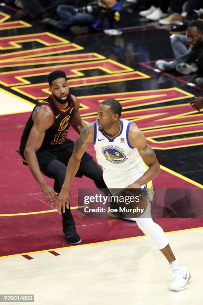 Andre Iguodala of the Golden State Warriors handles the ball against Tristan Thompson of the Cleveland Cavaliers in Game Four of the 2018 NBA Finals...