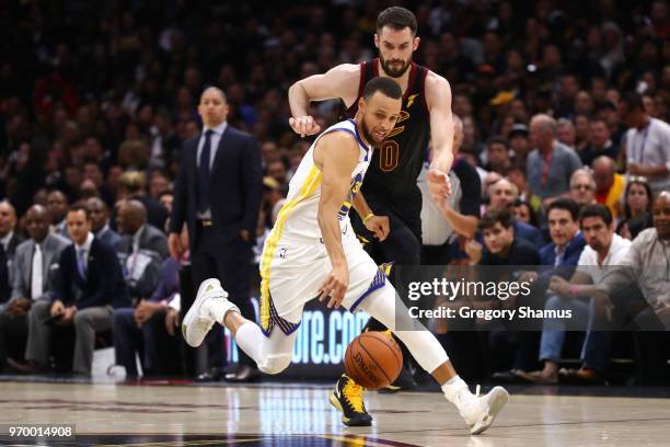 Stephen Curry of the Golden State Warriors controls the ball against Kevin Love of the Cleveland Cavaliers in the first quarter during Game Four of...