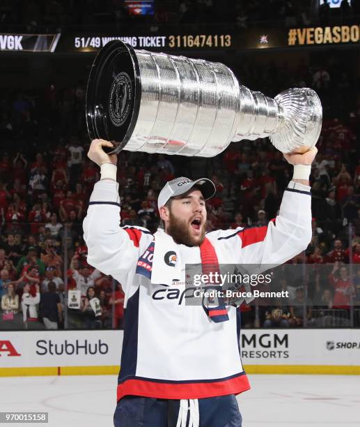 Tom Wilson of the Washington Capitals carries the Stanley Cup in celebration after his team defeated the Vegas Golden Knights 4-3 in Game Five of the...