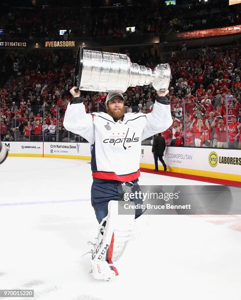 Braden Holtby of the Washington Capitals carries the Stanley Cup in celebration after his team defeated the Vegas Golden Knights 4-3 in Game Five of...