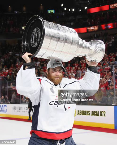 Braden Holtby of the Washington Capitals carries the Stanley Cup in celebration after his team defeated the Vegas Golden Knights 4-3 in Game Five of...