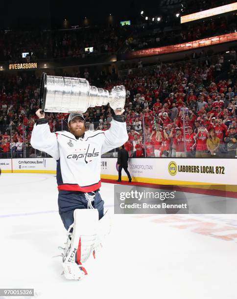 Braden Holtby of the Washington Capitals carries the Stanley Cup in celebration after his team defeated the Vegas Golden Knights 4-3 in Game Five of...