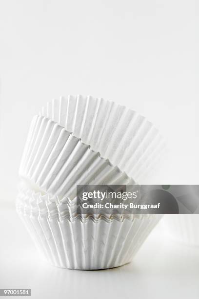 stack of white baking cups - cupcake holder stock pictures, royalty-free photos & images