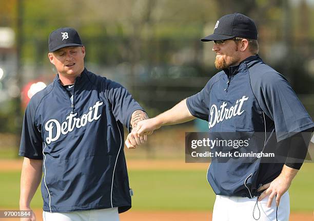 Jeremy Bonderman and Nate Robertson of the Detroit Tigers bump fists during the team's first full-squad spring training workout on February 23, 2010...