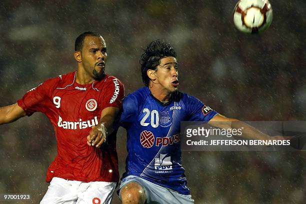 Ecuadorean Emelec's Pablo Javier Perez vies for the ball with Brazilian Internacional's Alecsandro during their Libertadores Cup football match at...