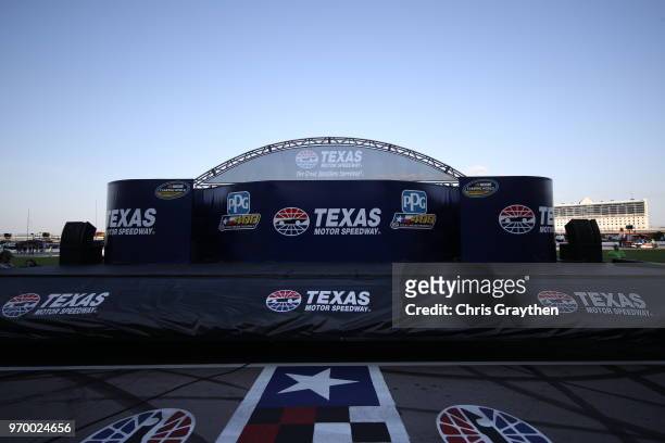 Pre-race stage empty with logos visible during the NASCAR Camping World Truck Series PPG 400 at Texas Motor Speedway on June 8, 2018 in Fort Worth,...