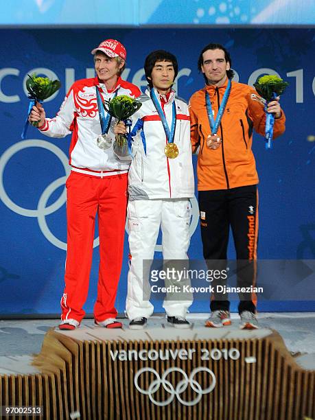 Ivan Skobrev of Russia celebrates winning silver, Lee Seung-Hoon of South Korea gold and Bob De Jong of Netherlands bronze during the medal ceremony...