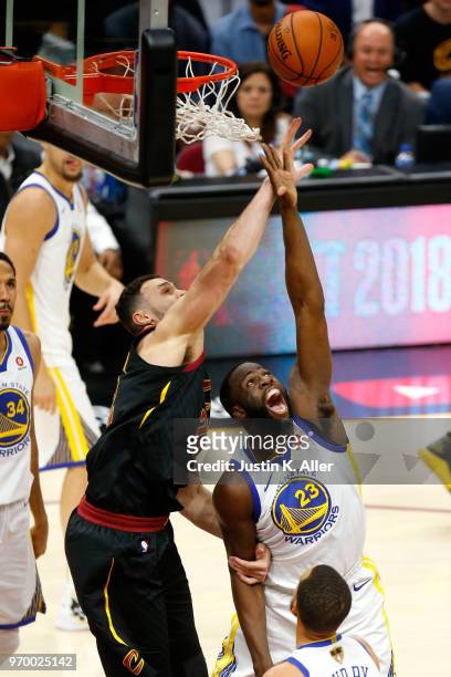 Larry Nance Jr. #22 of the Cleveland Cavaliers and Draymond Green of the Golden State Warriors compete for the ball in the first half during Game...