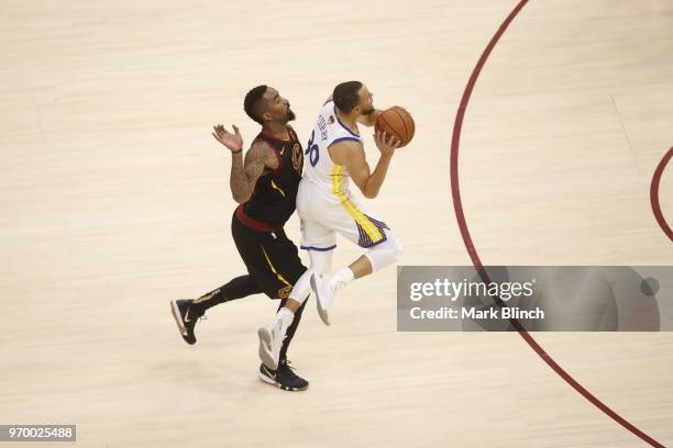 Stephen Curry of the Golden State Warriors shoots a three point basket while guarded by JR Smith of the Cleveland Cavaliers in Game Four of the 2018...