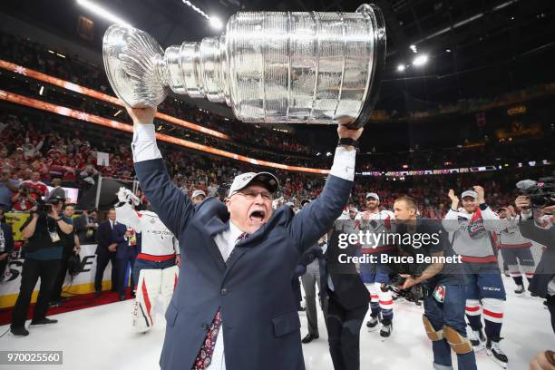 Head coach Barry Trotz carries the Stanley Cup in celebration after his team defeated the Vegas Golden Knights 4-3 in Game Five of the 2018 NHL...