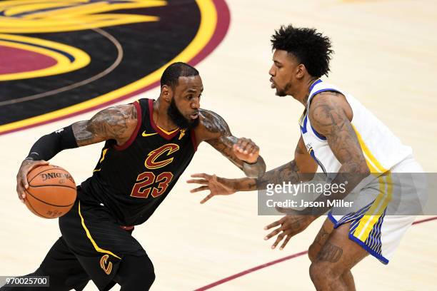 LeBron James of the Cleveland Cavaliers handles the ball against Nick Young of the Golden State Warriors in the first half during Game Four of the...