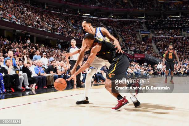 Rodney Hood of the Cleveland Cavaliers and Shaun Livingston of the Golden State Warriors go for the loose ball during Game Four of the 2018 NBA...