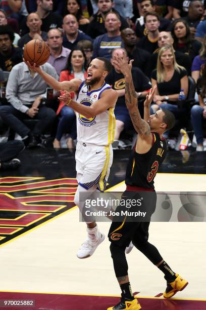 Stephen Curry of the Golden State Warriors goes to the basket over George Hill of the Cleveland Cavaliers in Game Four of the 2018 NBA Finals on June...