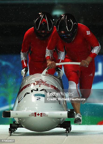 Kaillie Humphries and Heather Moyse of Canada compete in Canada 1 during the Women's Bobsleigh Heat 2 on day 12 of the 2010 Vancouver Winter Olympics...