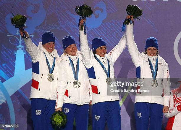 Team France celebrates winning the silver during the medal ceremony for the in the women's biathlon 4 x 6km relay on day 12 of the Vancouver 2010...