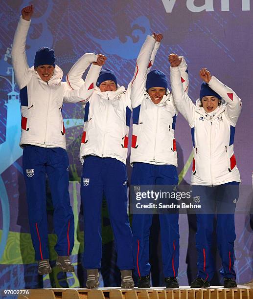 Team France celebrates winning the silver during the medal ceremony for the in the women's biathlon 4 x 6km relay on day 12 of the Vancouver 2010...