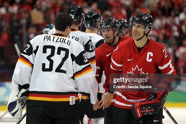 Scott Niedermayer of Canada shakes hands with Dimitri Patzold of Germany after their ice hockey Men's Qualification Playoff game between Germany and...