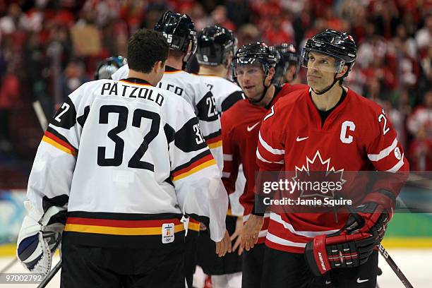 Scott Niedermayer of Canada shakes hands with Dimitri Patzold of Germany after their ice hockey Men's Qualification Playoff game between Germany and...