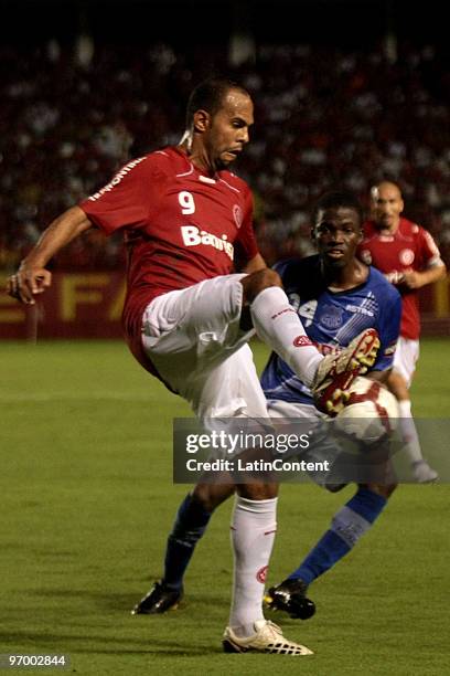 Player Alecsandro of Internacional vies for the ball with Valencia of Emelec during their soccer match as part of 2010 Libertadores Cup at Beira Rio...