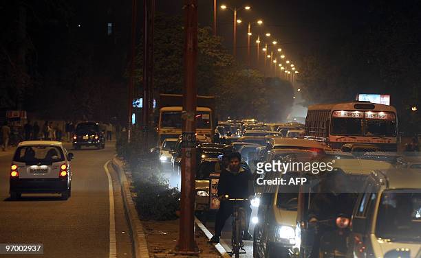 India-environment-noise-pollution,FEATURE by Elizabeth Roche Indian commuters halt in a traffic-jam at an intersection in New Delhi on February 18,...