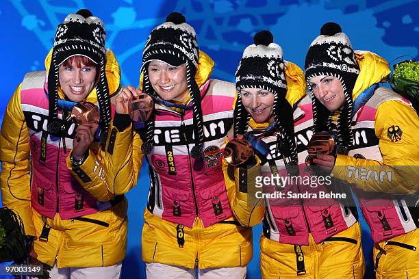 Team Germany celebrates winning the bronze during the medal ceremony for the in the women's biathlon 4 x 6km relay on day 12 of the Vancouver 2010...