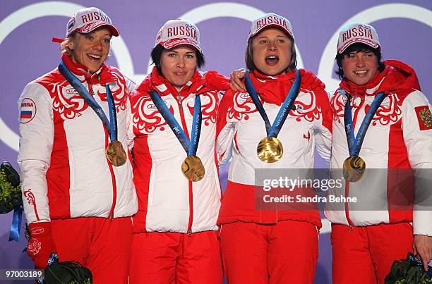 Team Russia celebrates winning the gold in the women's biathlon 4 x 6km relay during the medal ceremony on day 12 of the Vancouver 2010 Winter...