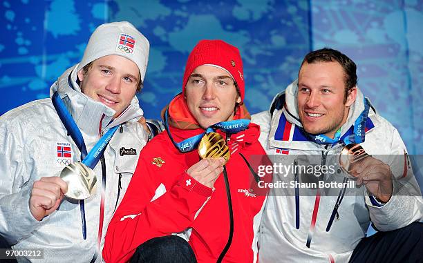 Silver medalist Kjetil Jansrud of Norway, gold medalist Carlo Janka of Switzerland and bronze medalist Aksel Lund Svindal of Norway pose after...