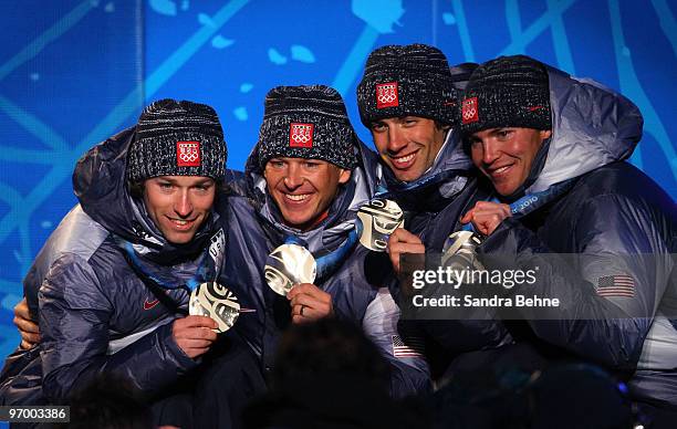 Team USA celebrates winning their silver in the Nordic Combined team relay during the medal ceremony on day 12 of the Vancouver 2010 Winter Olympics...