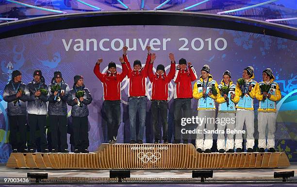 Team USA celebrates winning their silver, Team Austria Gold and Team Germany their Bronze in the Nordic Combined team relay during the medal ceremony...