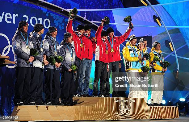 Team USA celebrates winning their silver, Team Austria Gold and Team Germany their Bronze in the Nordic Combined team relay during the medal ceremony...