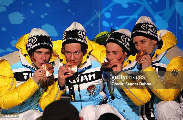 Team Germany celebrates winning their bronze in the Nordic Combined team relay during the medal ceremony on day 12 of the Vancouver 2010 Winter...