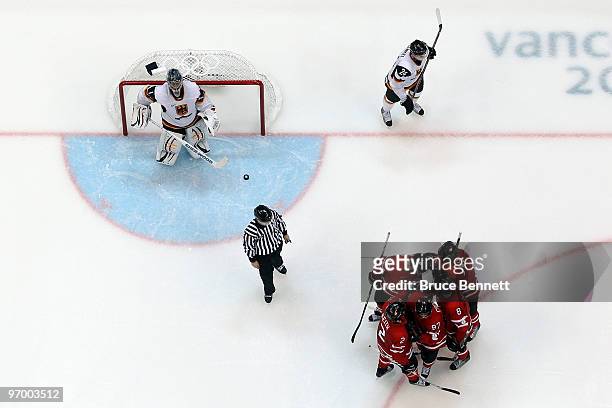 Sidney Crosby of Canada celebrates with teammates after he scored a goal in the third period against goalie Thomas Greiss of Germany during the ice...