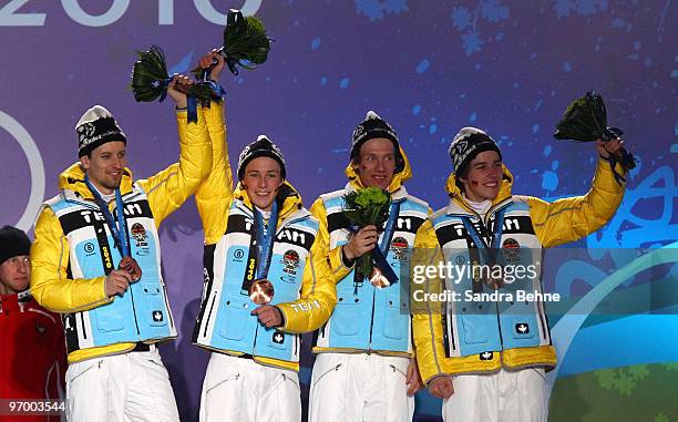 Team Germany celebrates winning their bronze in the Nordic Combined team relay during the medal ceremony on day 12 of the Vancouver 2010 Winter...