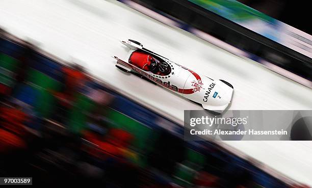 Kaillie Humphries and Heather Moyse of Canada compete in Canada 1 during the Women's Bobsleigh race on day 12 of the 2010 Vancouver Winter Olympics...
