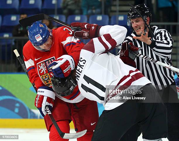 Fight breaks out between Tomas Fleischmann of Czech Republic and Kristaps Sotnieks of Latvia during the ice hockey Men's Play-off qualification match...