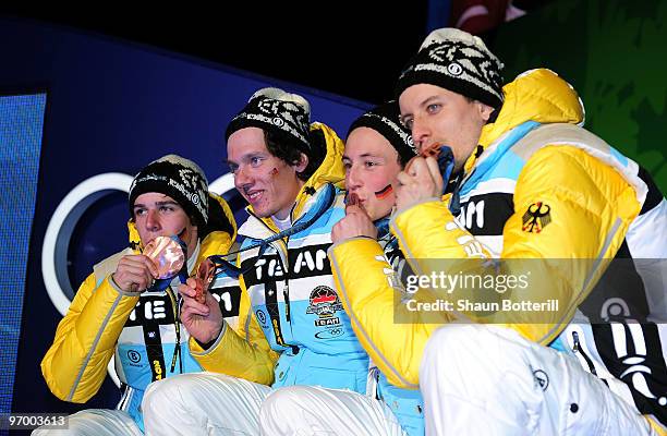 Team Germany celebrates winning their bronze in the Nordic Combined team relay during the medal ceremony on day 12 of the Vancouver 2010 Winter...