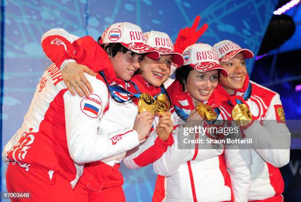 Team Russia celebrates winning the gold in the women's biathlon 4 x 6km relay during the medal ceremony on day 12 of the Vancouver 2010 Winter...