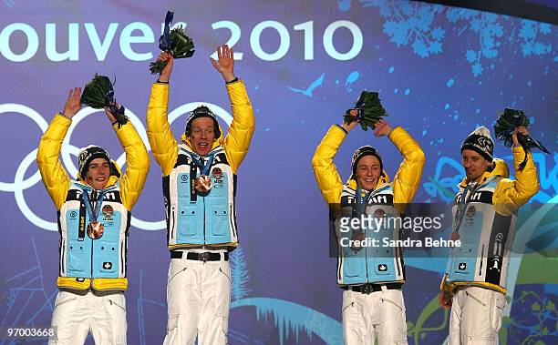 Team Germany celebrates winning their bronze in the Nordic Combined team relay during the medal ceremony on day 12 of the Vancouver 2010 Winter...