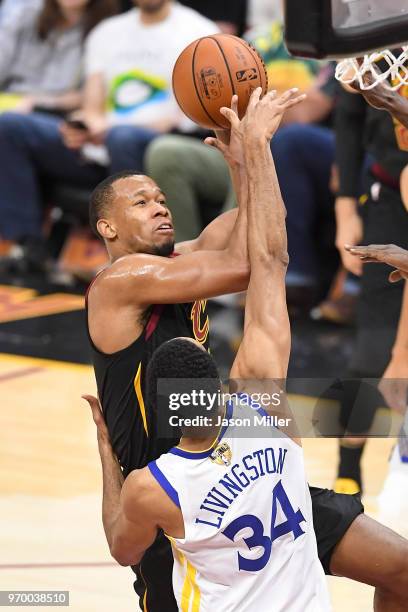 Rodney Hood of the Cleveland Cavaliers attempts a layup over Shaun Livingston of the Golden State Warriors in the first half during Game Four of the...