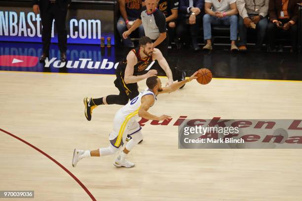 Stephen Curry of the Golden State Warriors beats Kevin Love of the Cleveland Cavaliers to a loose ball in Game Four of the 2018 NBA Finals on June 8,...
